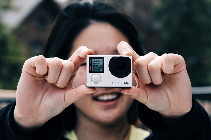 woman-taking-photo-with-gopro-camera.jpg